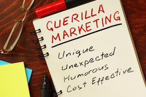 A note pad with the words Guerilla marketing on it