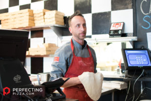 a photo of joe carlucci holding dough
