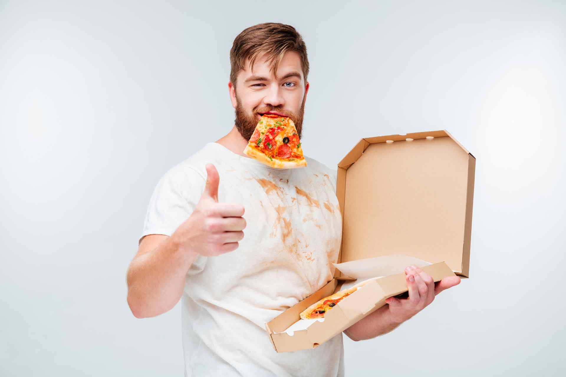 guy eating pizza giving thumbs up with a greasy shirt