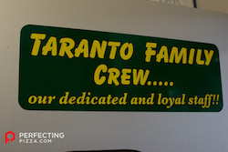 a photo of a sign in yellow text saying Taranto family crew our dedicated and loyal staff