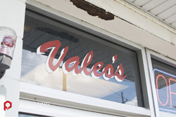 The word Valeo's on a window of the restaurant