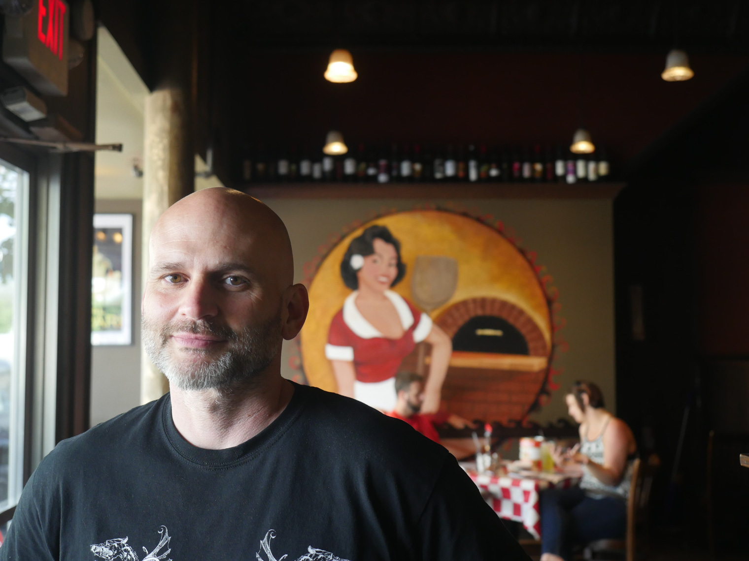 Photo of Michael Shepherd standing in pizzeria