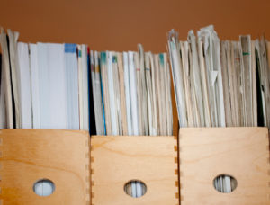 Magazines inside holders sitting on a shelf