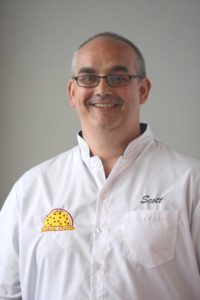 Head shot of Scott Anthony in a white chef coat